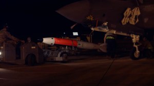 US Air Force and Energy Department personnel load unarmed nuclear bombs into F-35
