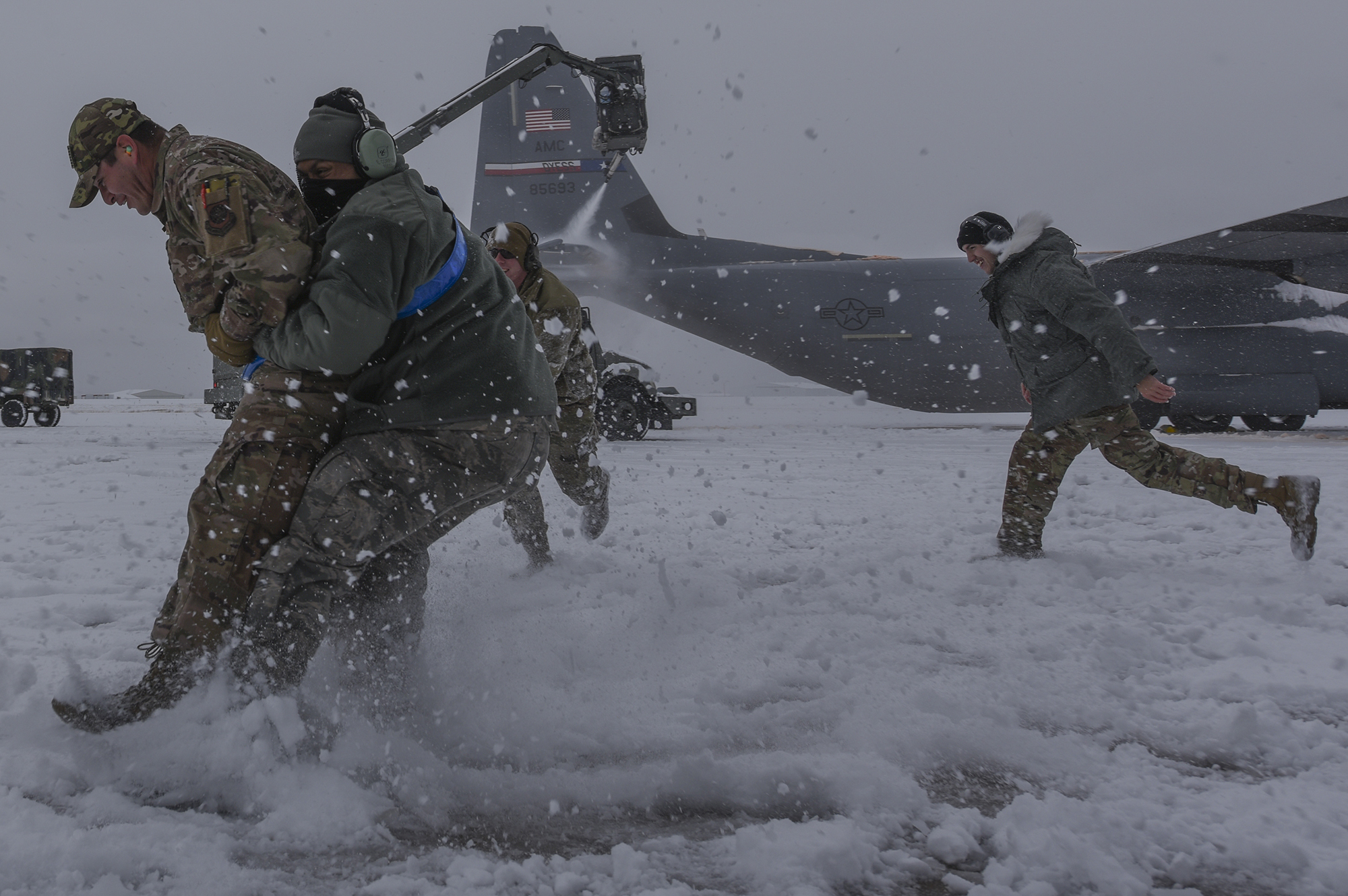Hercules Airmen de-ice aircraft, re-ice each other