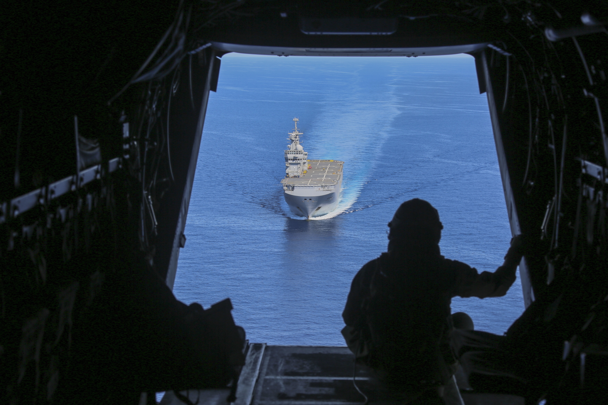 Cpl. Tyler Truong, MV-22B Osprey crew chief, observes the French Navy amphibious assault ship Mistral on June 24, 2020, in the Mediterranean Sea.