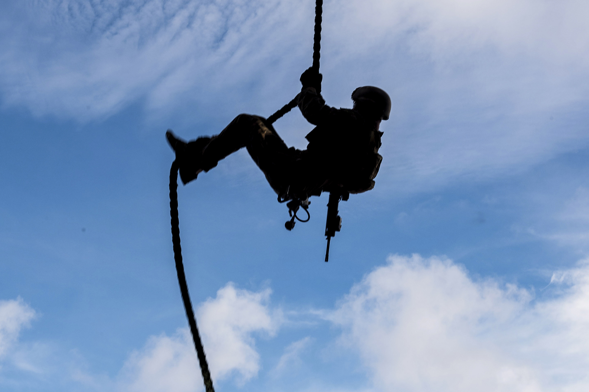 A Marine conducts fast-rope sustainment training on the flight deck of the forward-deployed amphibious assault ship USS America (LHA 6) on Aug. 23, 2020, in the Philippine Sea.