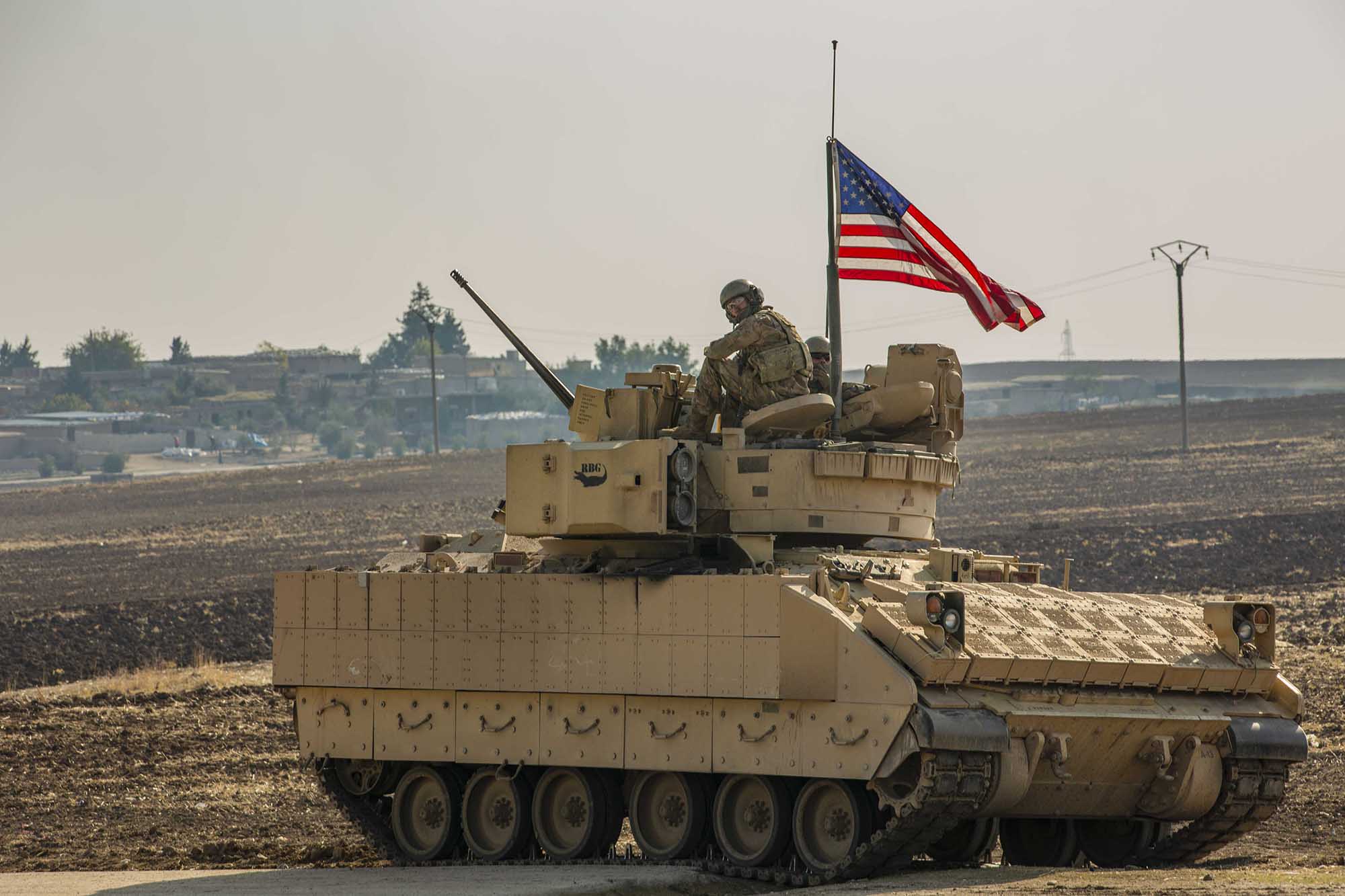 A U.S. soldier sits in the gunner’s seat of a M2 Bradley Infantry Fighting Vehicle in Syria in the Central Command area of responsibility, Dec. 11, 2020.