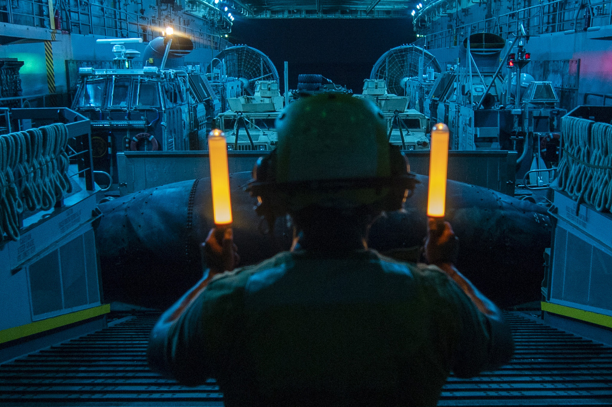 Seaman Juan Rivera signals a landing craft, air cushion Aug. 23, 2019, during well deck operations aboard the amphibious transport dock ship USS John P. Murtha (LPD 26) in the Red Sea.