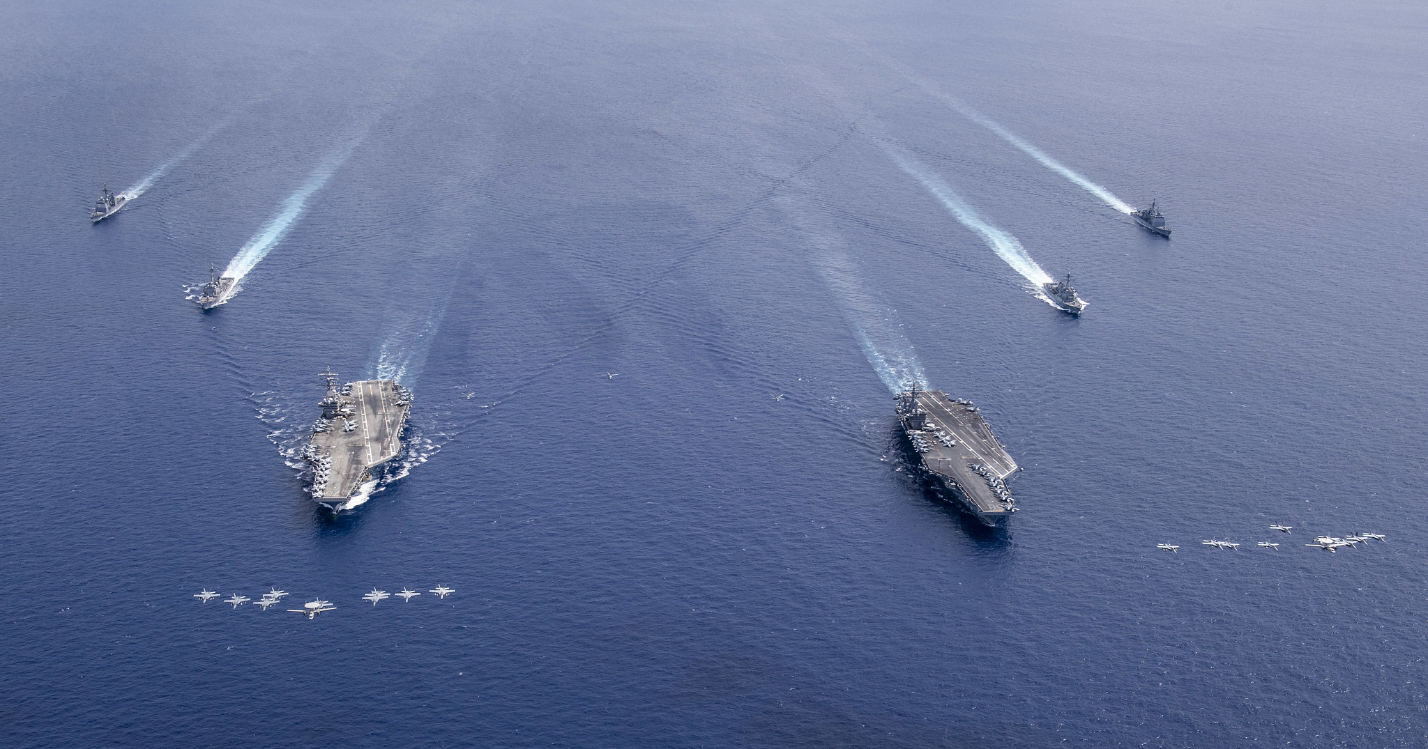 Aircraft from Carrier Air Wings (CVW) 5 and 17 fly in formation over the Nimitz Carrier Strike Force on July 6, 2020, in the South China Sea.