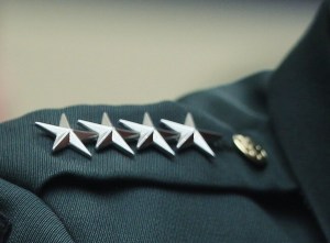 Top officers take extra hit to pay and benefits