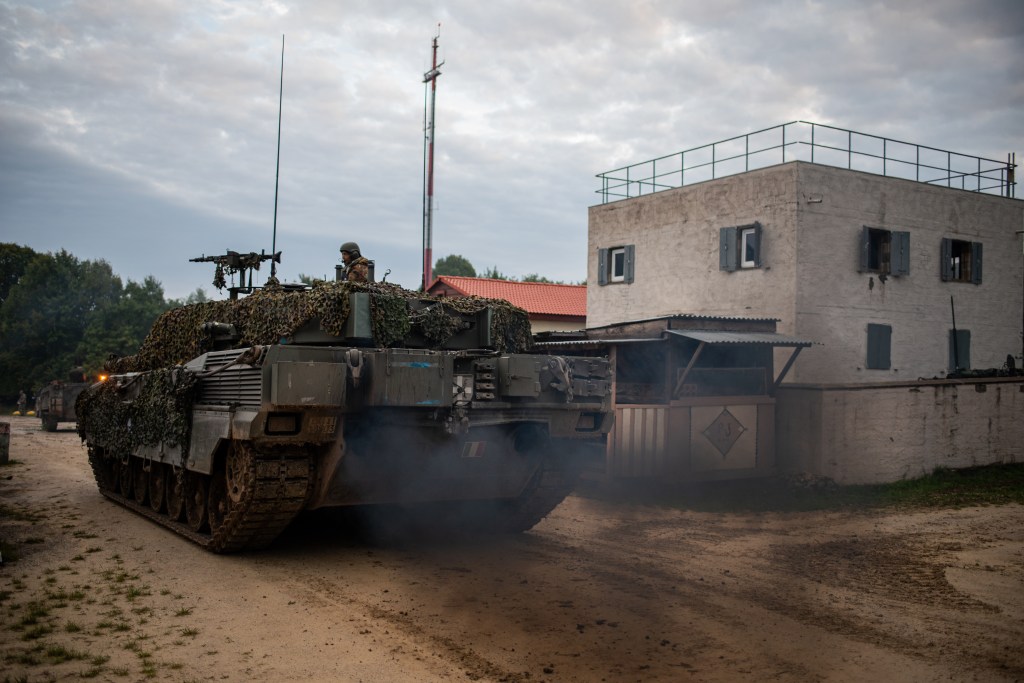 Cash in hand for armored vehicles, Italy weighs its clout in Europe
