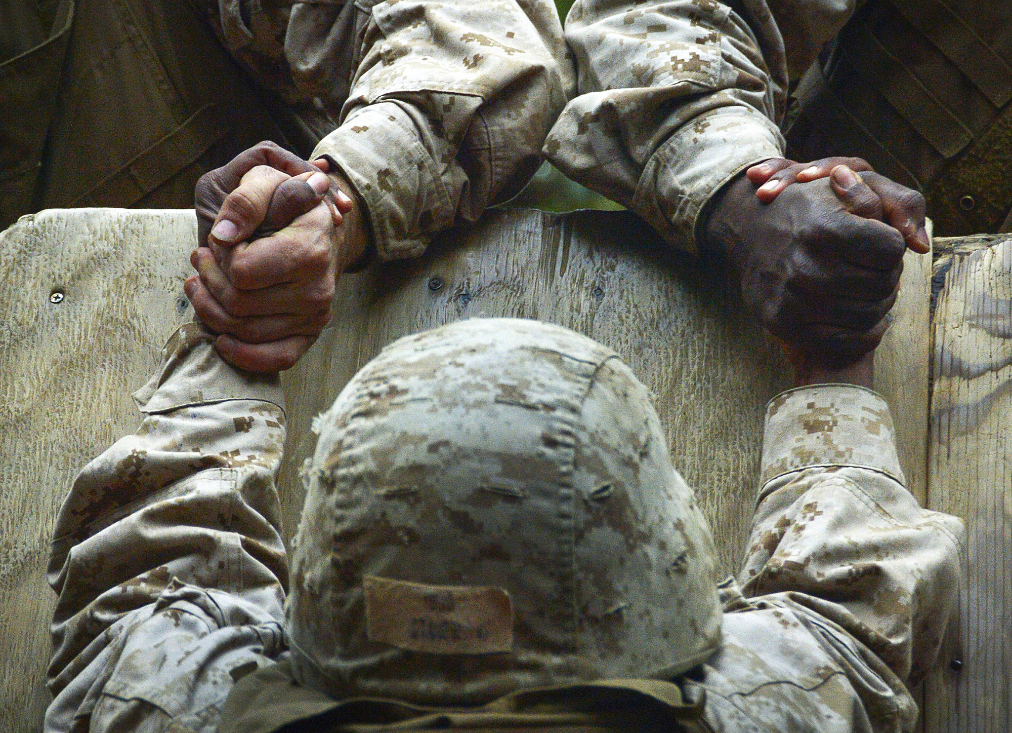 Recruits from Company C help a fellow recruit climb an 8-foot wall at Parris Island, S.C., Dec. 14, 2012