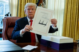 Trump signs, lauds tax overhaul, off to Florida for holidays