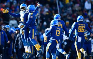 Abey’s 5 TDs help Navy beat Virginia 49-7 in Military Bowl