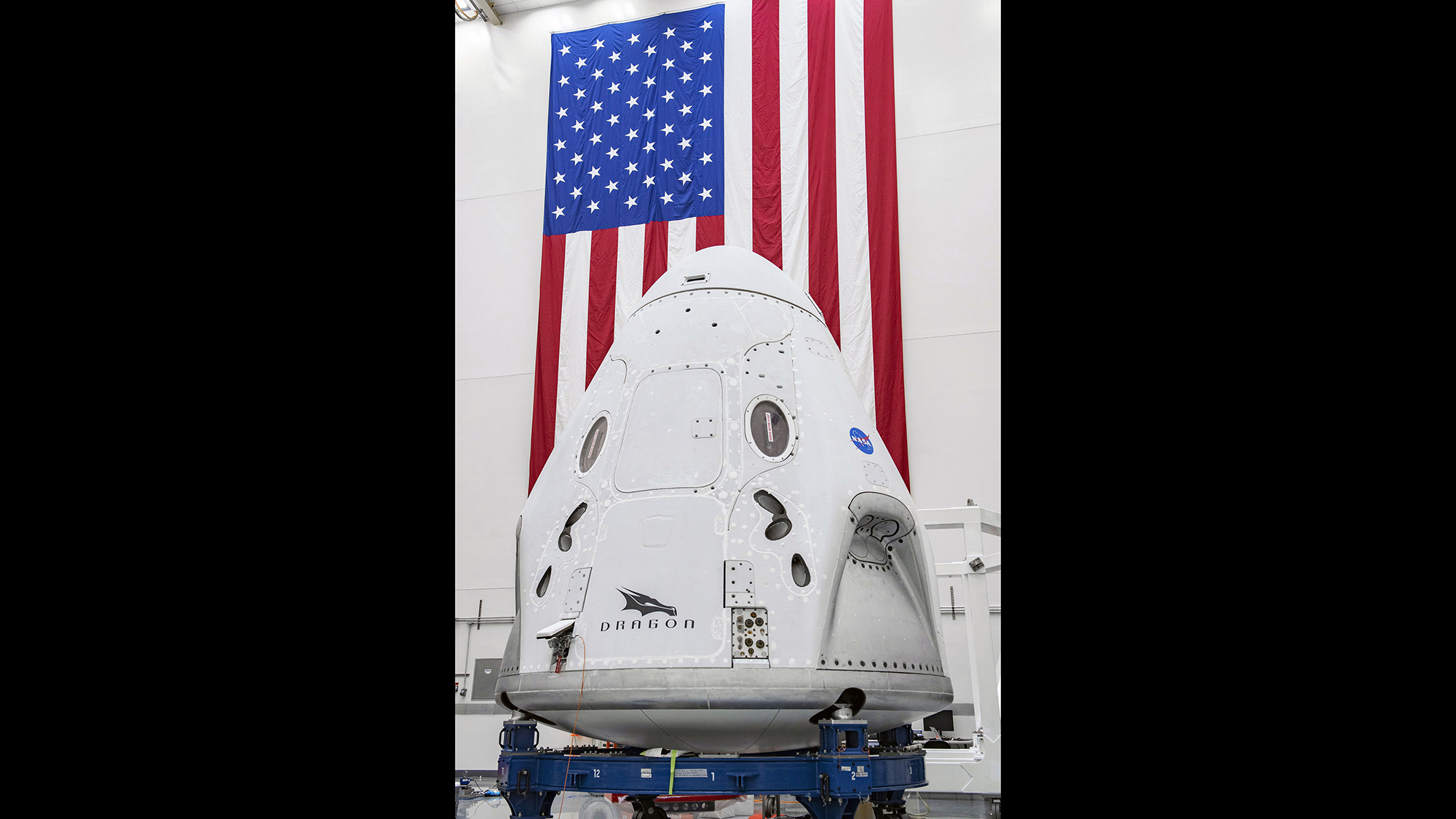In this April 10, 2020, photo made available by SpaceX, the SpaceX Crew Dragon spacecraft undergoes final processing at Cape Canaveral Air Force Station, Fla.