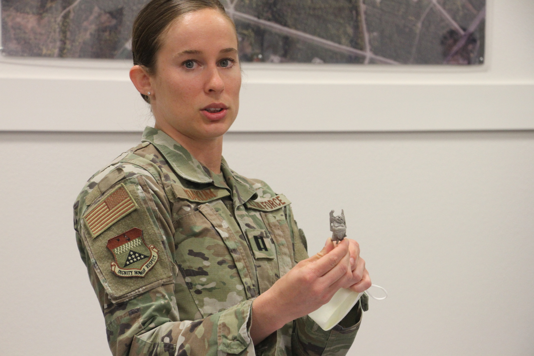 Air Force Capt. Shelby Yoakum shows a lucky Buddha figurine on June 26, 2020, at Joint Base Elmendorf-Richardson, Alaska