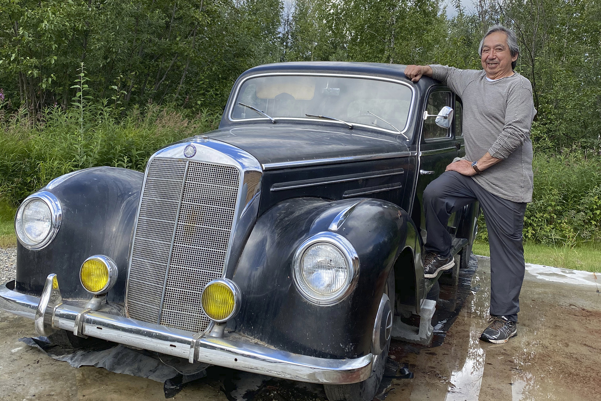 This undated photo shows Wally Carlo posing with a 1951 Mercedes that his brother, Stewy, bought while he was serving in the Army during the Vietnam War.