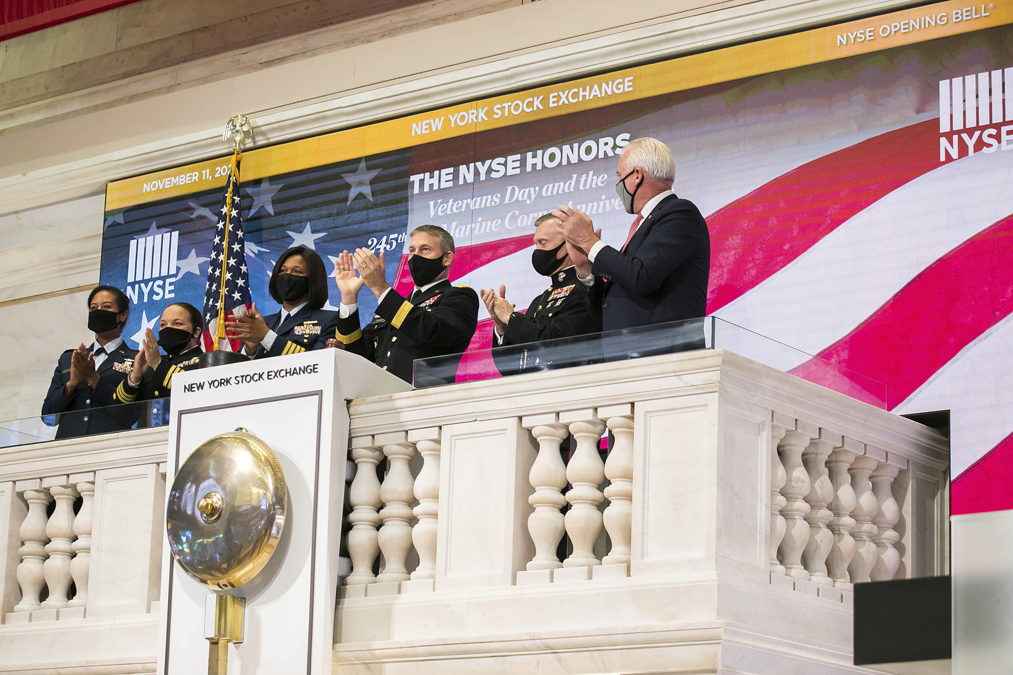 Members of the U.S. Coast Guard, Air Force, Navy and Army ring the opening bell at the New York Stock Exchange on Veterans Day, Wednesday, Nov. 11, 2020, in New York.