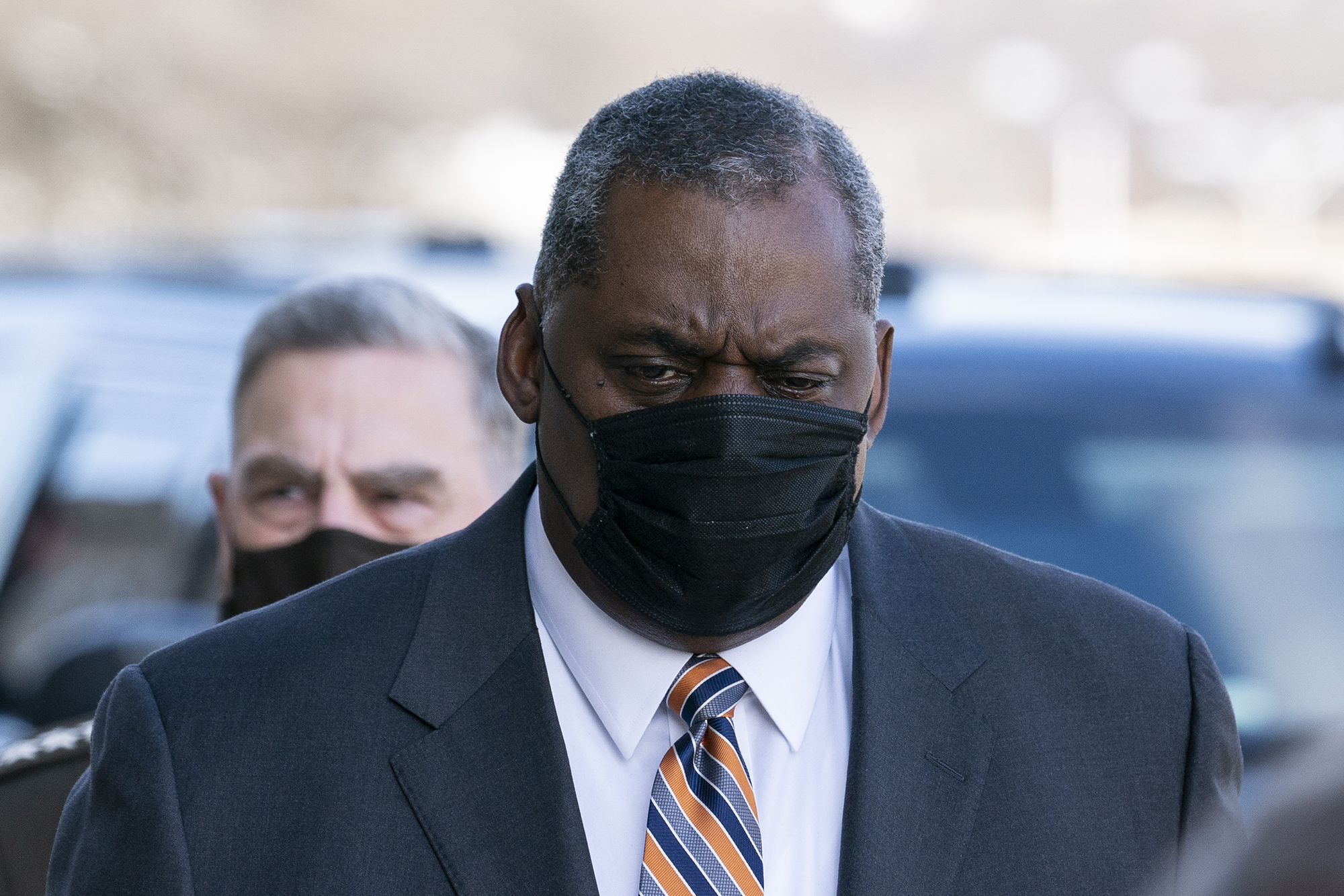 Defense Secretary Lloyd Austin arrives at the Pentagon, followed by Joint Chiefs Chairman Gen. Mark Milley on Jan. 22, 2021, in Washington.