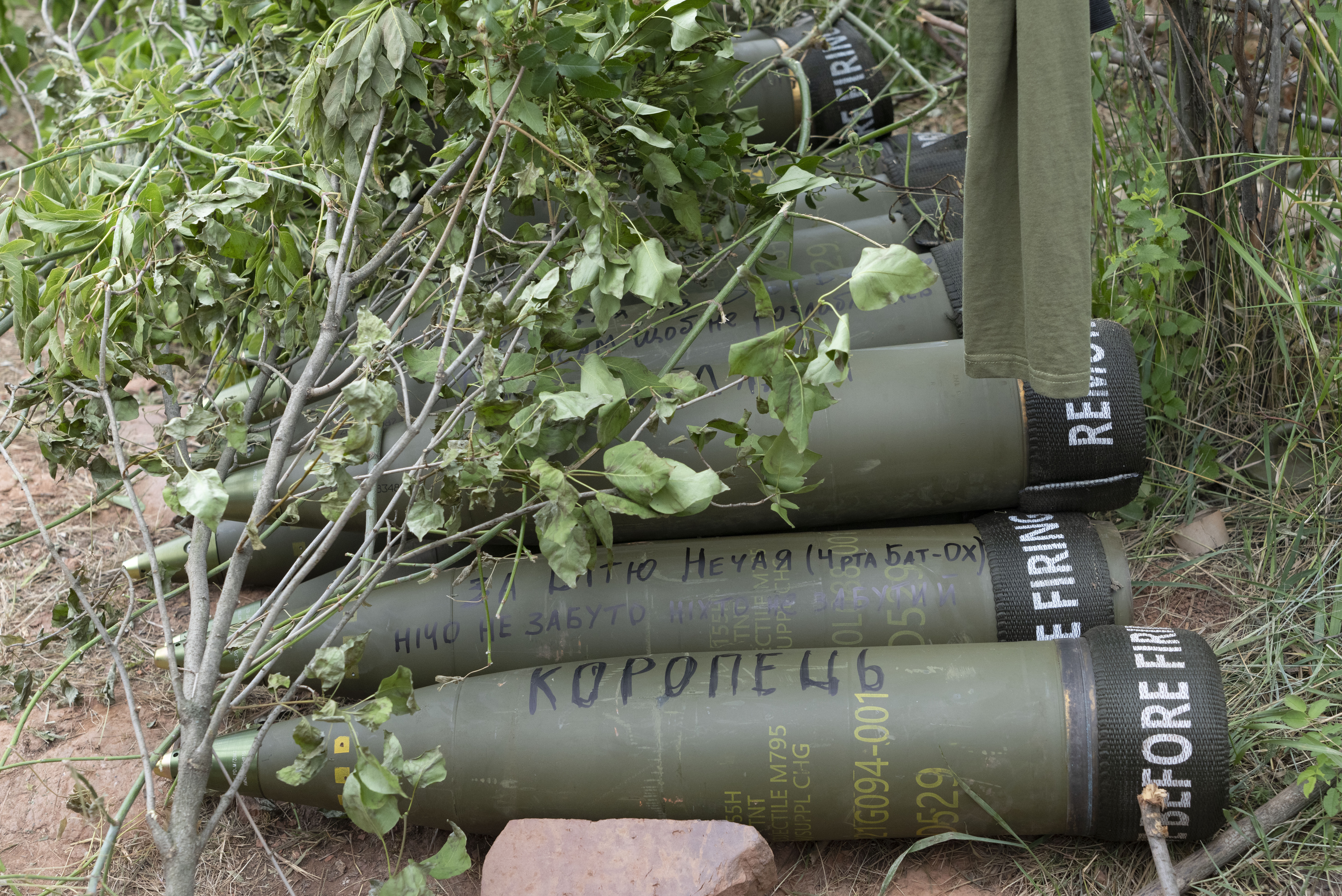 U.S.-supplied M777 howitzer shells lie on the ground to fire at Russian positions in Ukraine's eastern Donbas region June 18, 2022.
