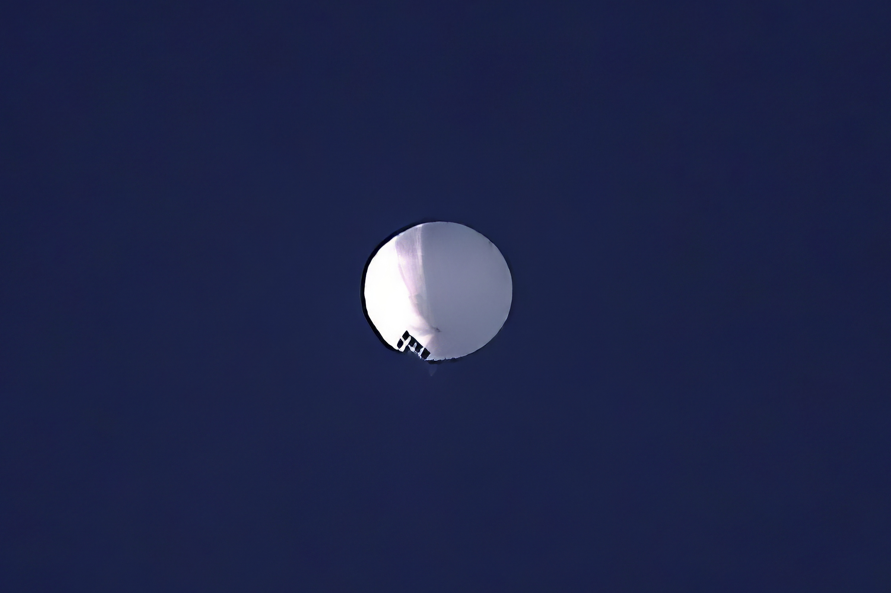 A high altitude balloon floats over Billings, Mont., on Wednesday, Feb. 1, 2023. The huge, high-altitude Chinese balloon sailed across the U.S. on Friday, drawing severe Pentagon accusations of spying and sending excited or alarmed Americans outside with binoculars.