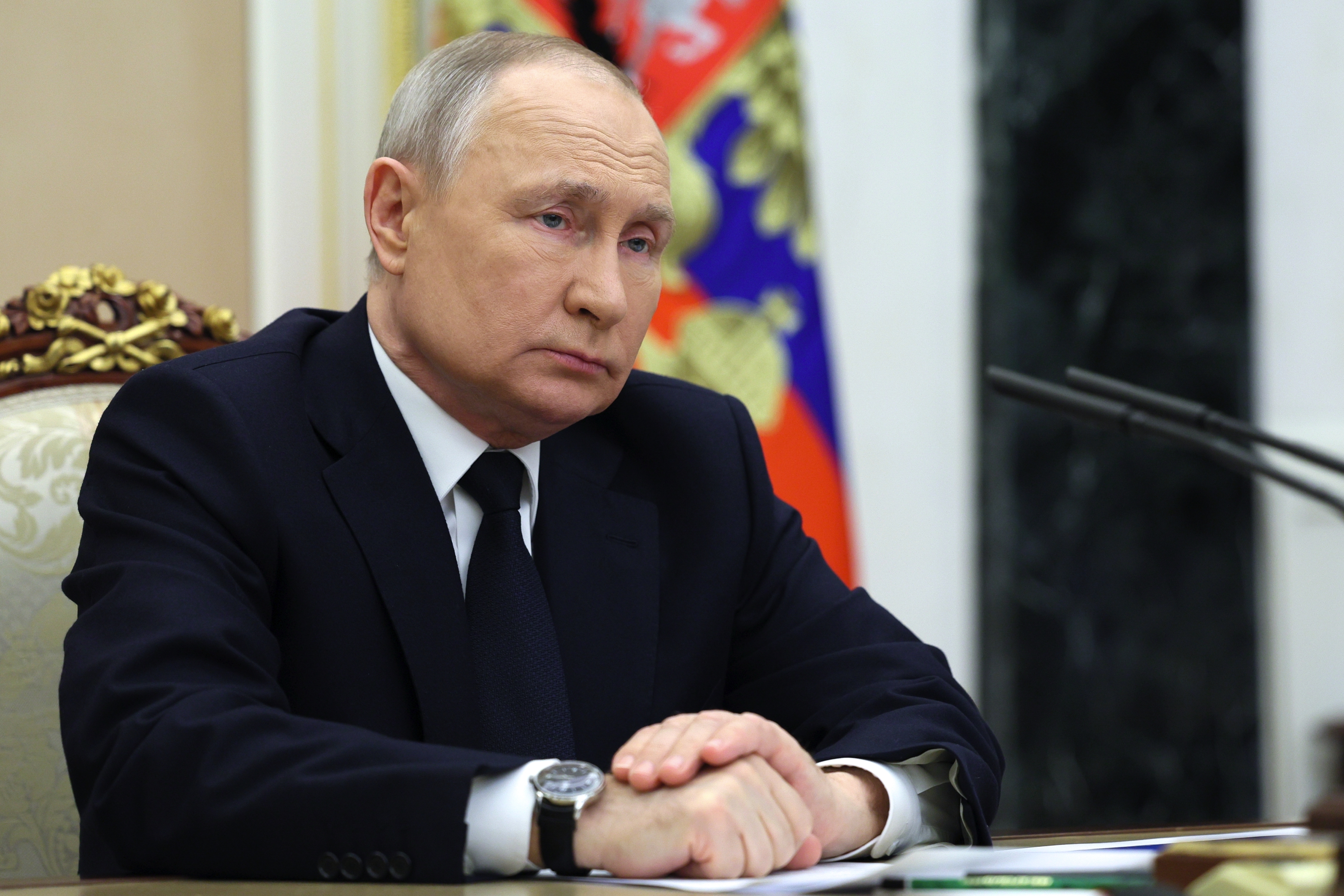 Russian President Vladimir Putin listens to Russian Transport Minister Vitaly Savelyev during their meeting in Moscow, Russia, Saturday, March 25, 2023.