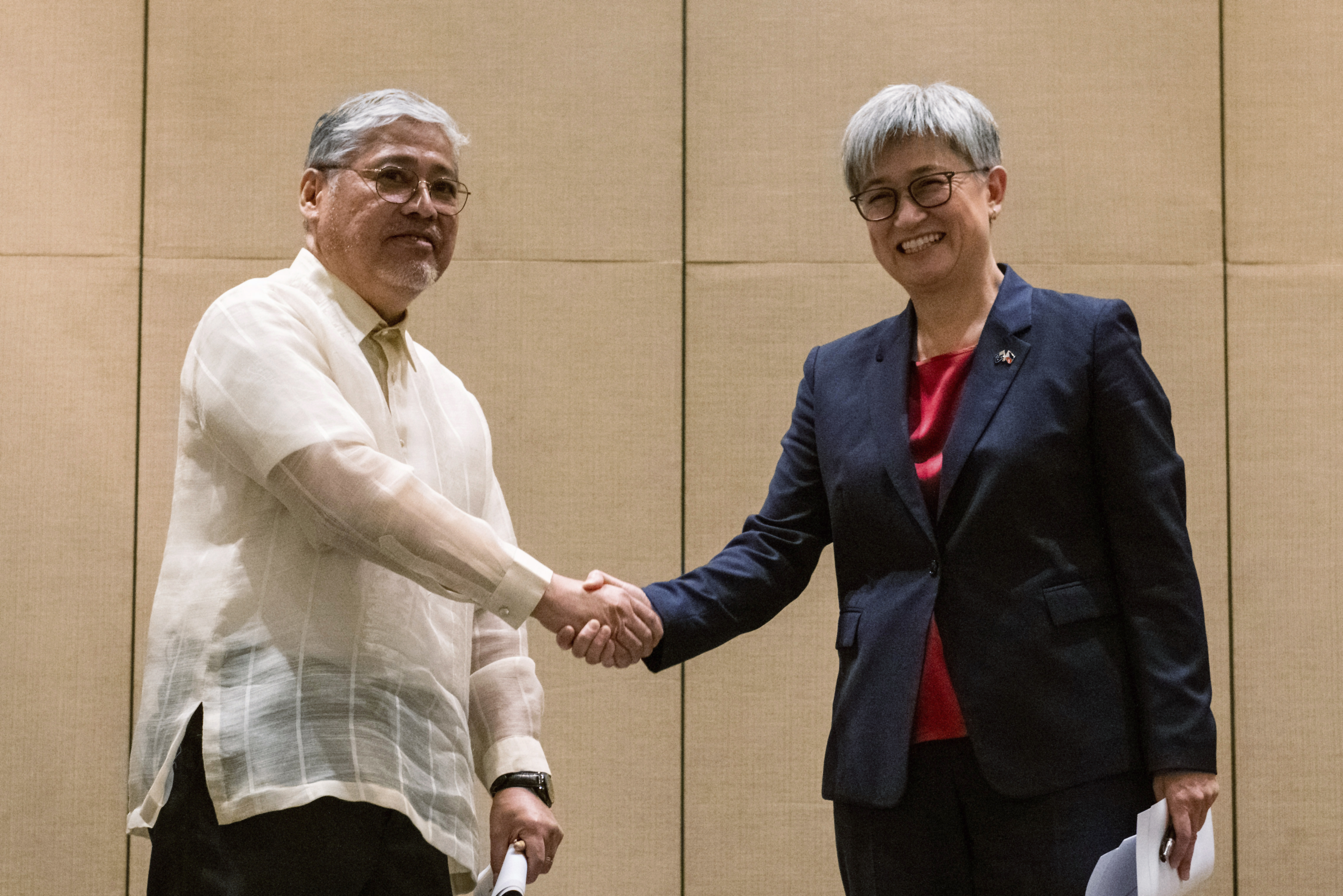 Australian Foreign Minister Penny Wong, right, shakes hands with Philippine Foreign Affairs Secretary Enrique Manalo during a joint press conference at a hotel in Makati City, Philippines on Thursday May 18, 2023.
