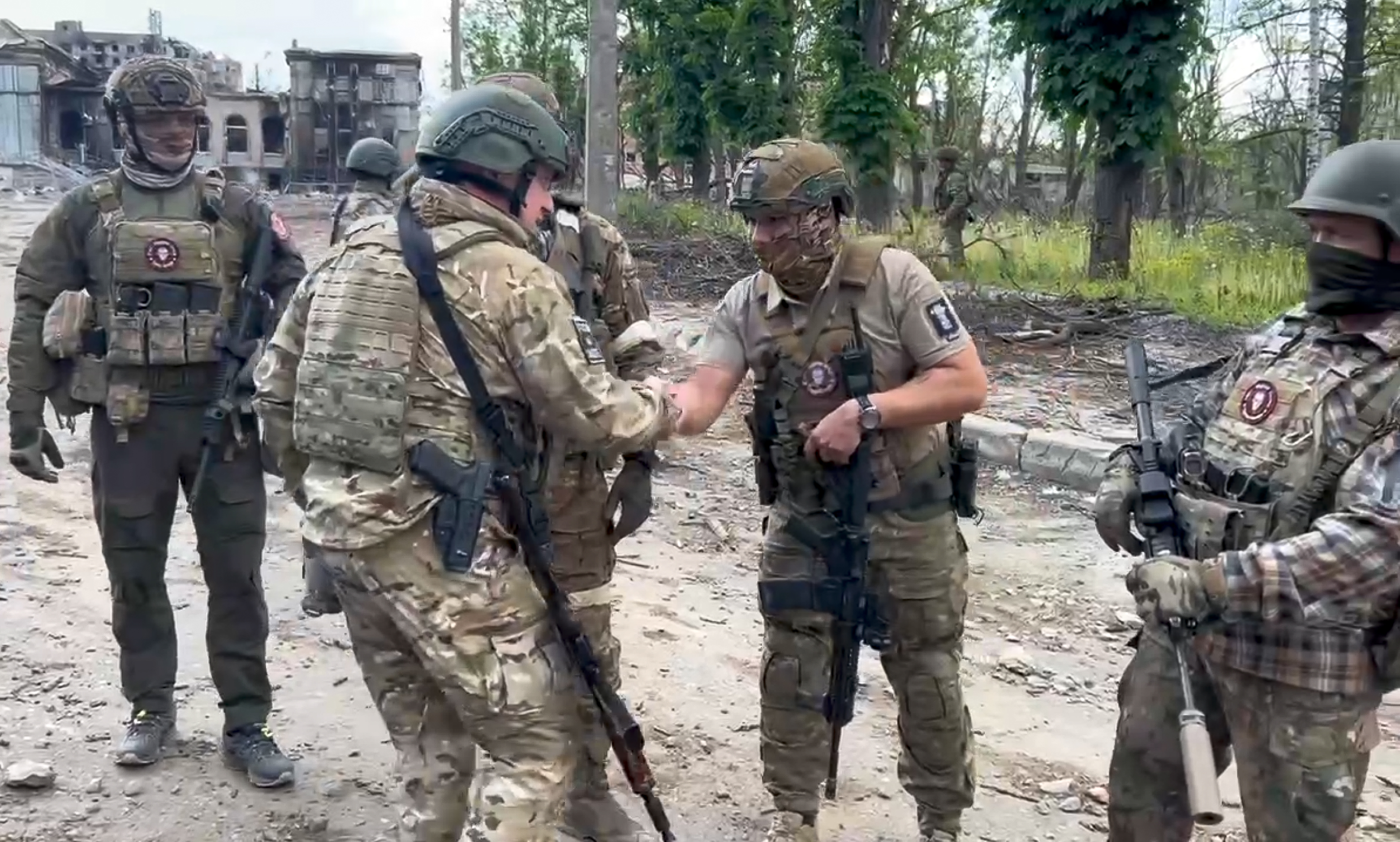 In this grab taken from video released by Prigozhin Press Service on Saturday, May 20, 2023, Yevgeny Prigozhin, the owner of the Wagner Group military company shakes hands with his soldiers, in Bakhmut, Ukraine.