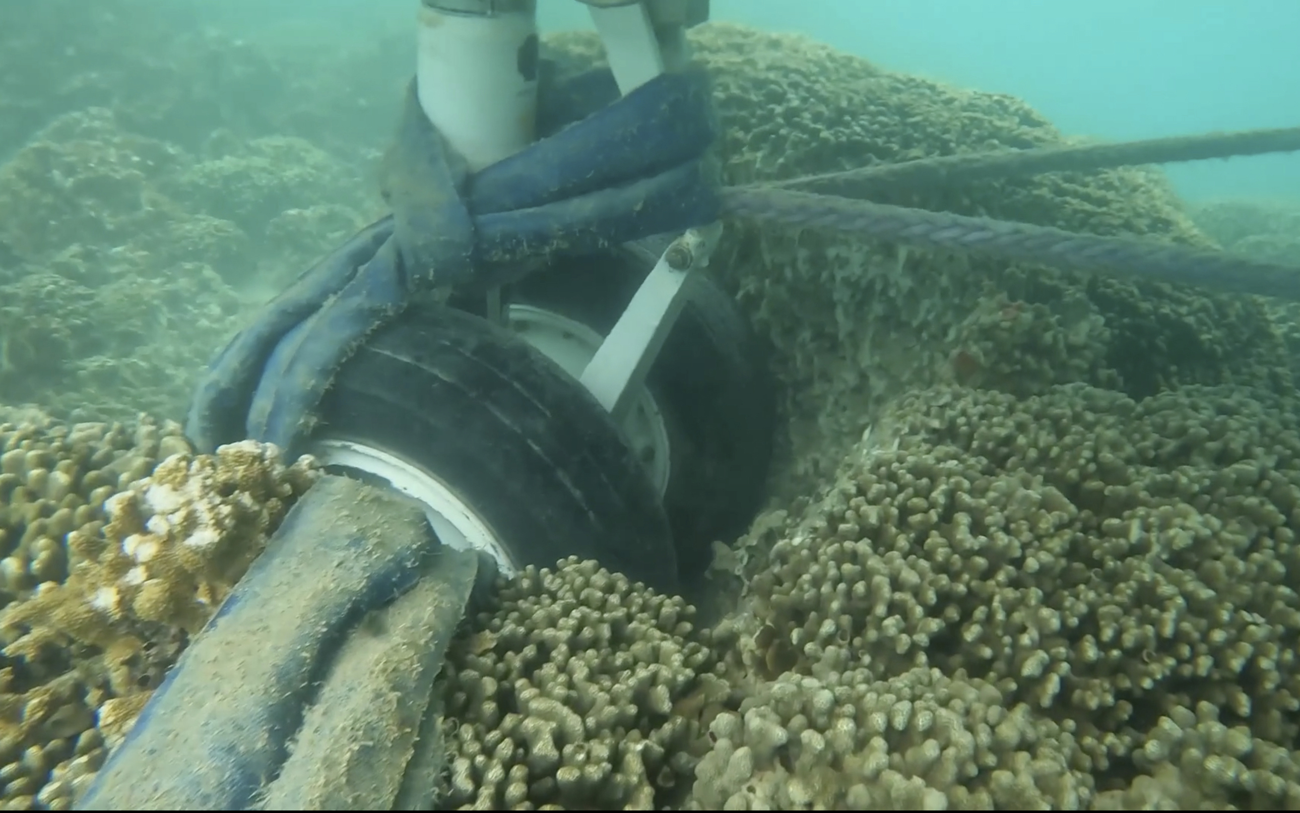 In this image taken from video provided by the U.S. Navy, Navy divers assigned to Mobile Diving and Salvage Unit One conduct an underwater survey of the U.S. Navy's P-8A Poseidon in Kaneohe Bay, Hawaii, on Tuesday, Nov. 28, 2023