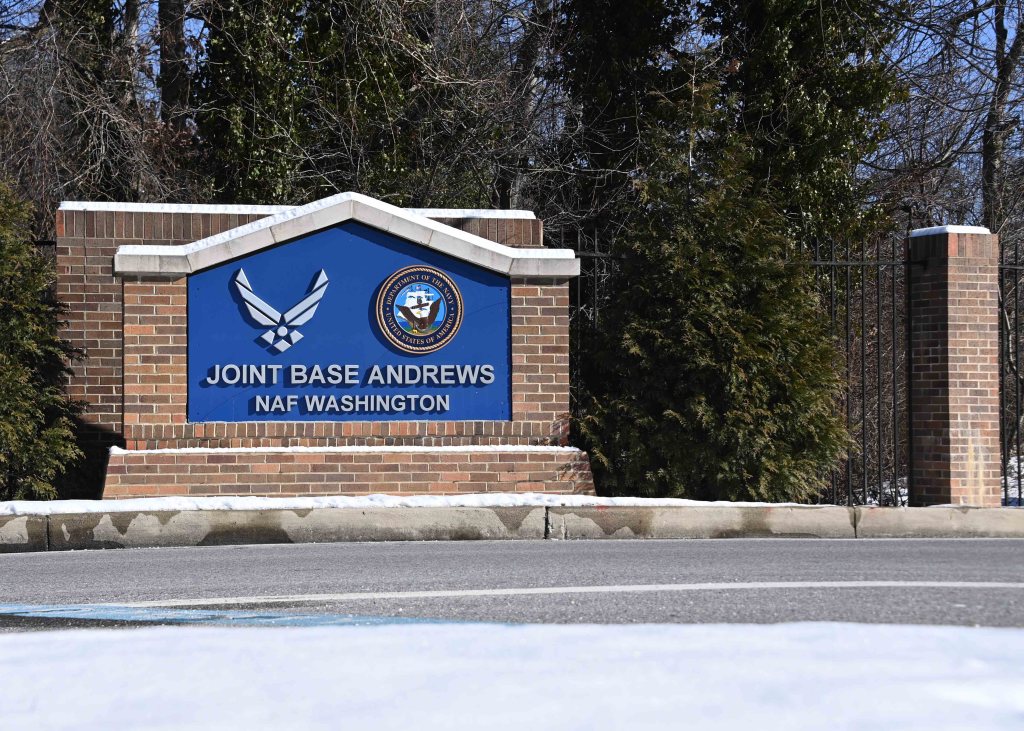 A Joint Base Andrews sign sits outside with snow on top.