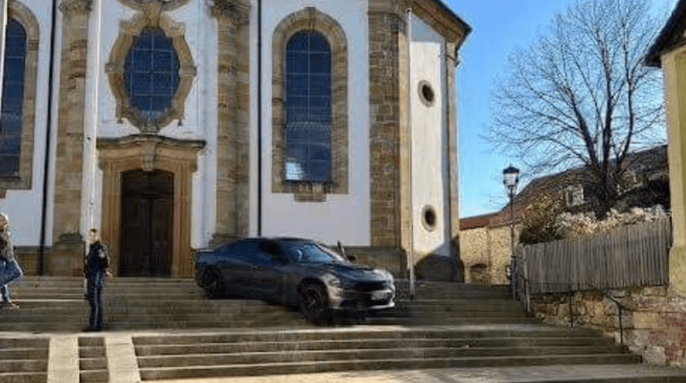 GPS navigation strands US-made Dodge Charger on German church steps
