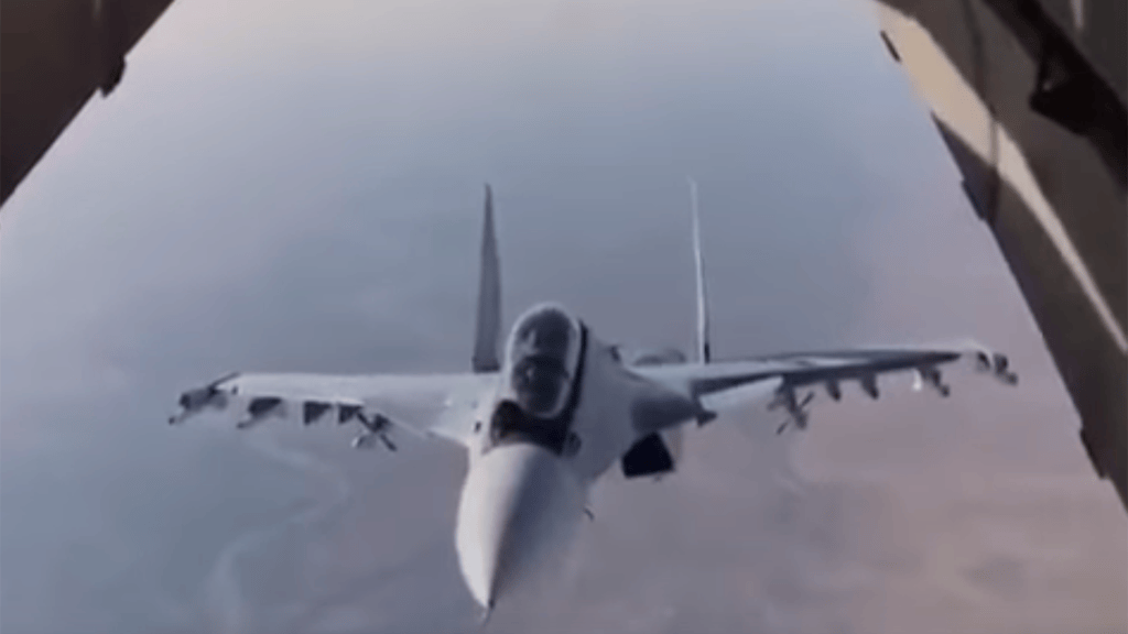 Whoops? Transport plane’s cargo comes within feet of a Russian Su-30SM mid-flight