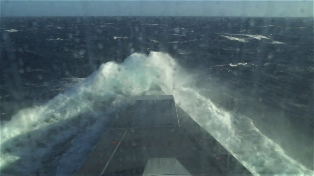 The stealth destroyer Zumwalt sails through rough seas testing